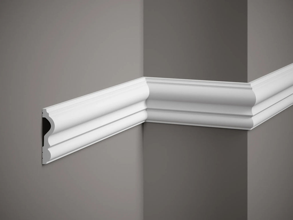 Decorative white crown molding on a gray wall