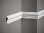 Decorative white crown molding on a gray wall