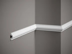 White crown molding on a gray wall
