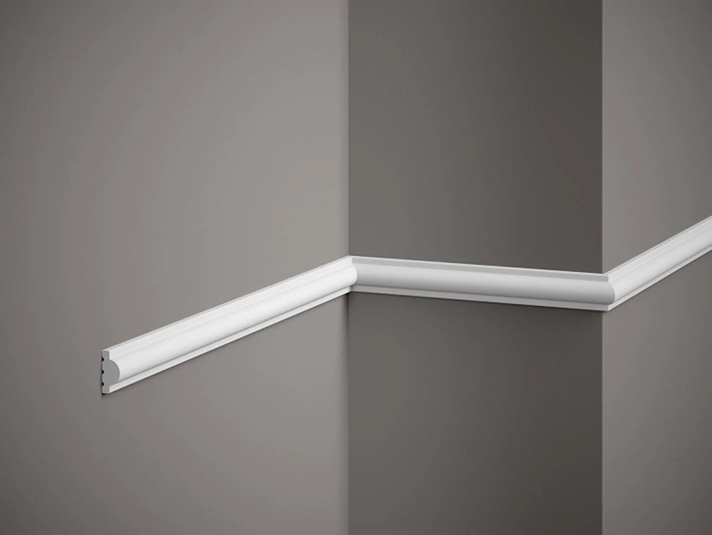 White crown molding on a gray wall corner