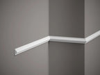 White crown molding on a gray wall corner