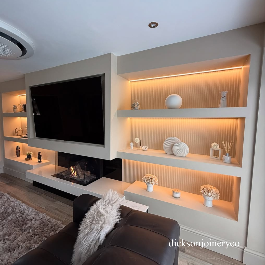 Modern living room with a television mounted on a wall with built-in shelves and panelling