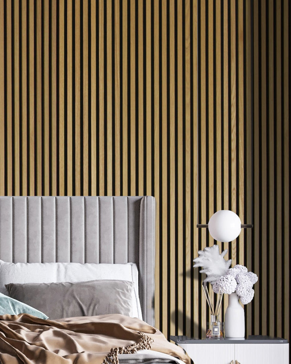 Bedroom with acoustic panelling, gray headboard, and white nightstand with decorative items.