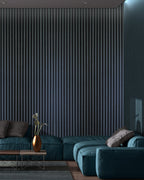 Modern living room with teal sofa and charcoal acoustic panelling
