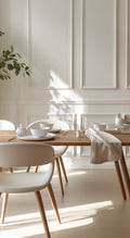 Dining area with wooden table and white chairs in a bright room with wall panelling.